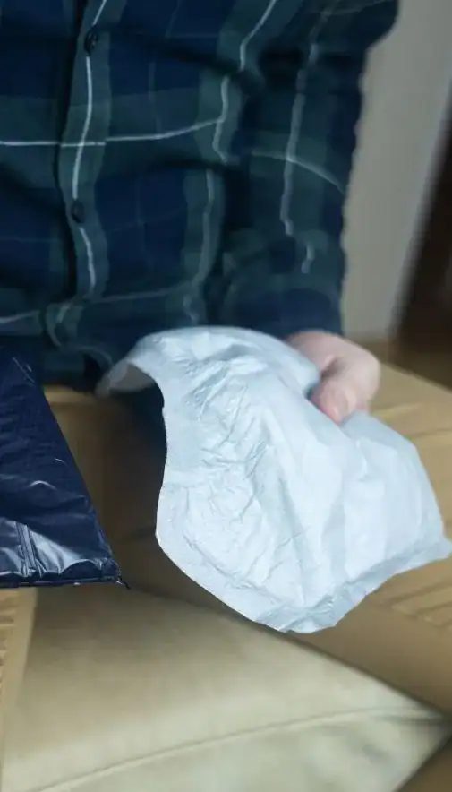 Image of man holding incontinence pads as part of overactive bladder treatment Birmingham