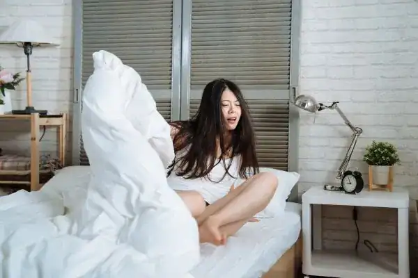 Image of woman getting up because of nighttime leaks Birmingham